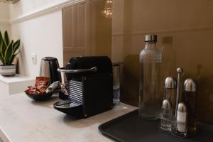a black toaster sitting on a counter next to a bottle at Villa Clio, a Luxury Collection in Thessaloniki