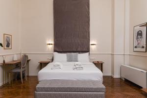 a bedroom with a bed and a desk with a chair at Villa Clio, a Luxury Collection in Thessaloniki