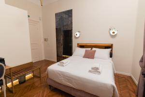 a bedroom with a large white bed and a desk at Villa Clio, a Luxury Collection in Thessaloniki