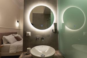 a bathroom with a sink and a mirror and a bed at Villa Clio, a Luxury Collection in Thessaloniki +37 photos