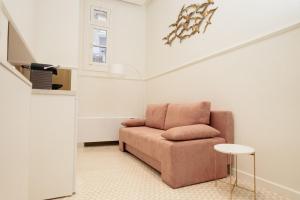a living room with a chair and a tv at Villa Clio, a Luxury Collection in Thessaloniki