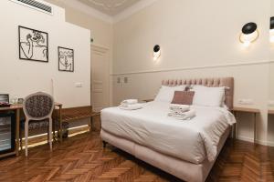 a bedroom with a bed with a desk and a chair at Villa Clio, a Luxury Collection in Thessaloniki