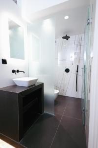 a bathroom with a sink and a glass shower at Villa Clio, a Luxury Collection in Thessaloniki