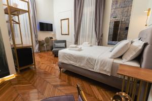a hotel room with a bed and a chair at Villa Clio, a Luxury Collection in Thessaloniki