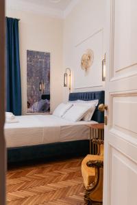 a bedroom with a bed and a blue curtain at Villa Clio, a Luxury Collection in Thessaloniki