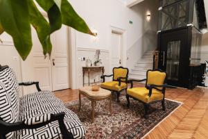a living room with chairs and a fireplace at Villa Clio, a Luxury Collection in Thessaloniki