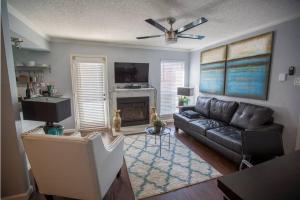 a living room with a couch and a fireplace at I14 - DFW Condo Near Baylor 2BD/1BA in Irving