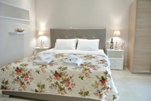a bedroom with a large bed with a floral bedspread at luxury studios ath in Limenas
