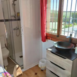 a bathroom with a sink and a glass shower at Stunning Villa Felipe, with private pool & hot tub in Almogía