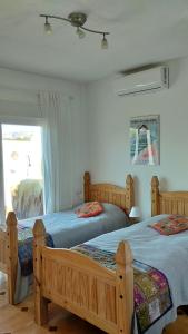 two twin beds in a bedroom with a window at Stunning Villa Felipe, with private pool & hot tub in Almogía