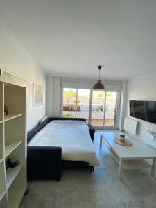 a bedroom with a large bed and a table at Casa con piscina y chimenea en Albayzin alto in Granada