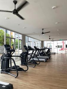 a row of exercise bikes lined up in a gym at Tifa Home, Alanis Residence Kota Warisan KLIA Sepang Netflix in Sepang +6 photos