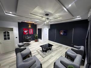 a living room with chairs and a black wall at 99 MOZILLA APARTMENTS AND SUITES in Abuja