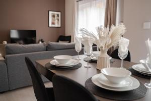 a dining room table with black chairs and a gray couch at Stylish & recently refurbished Chester apartment - Up to 6 in Chester