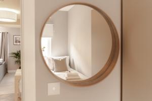 a round mirror hanging on a wall in a living room at Stylish & recently refurbished Chester apartment - Up to 6 in Chester +20 photos