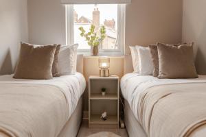 2 letti posti uno accanto all'altro in una camera da letto di Stylish & recently refurbished Chester apartment - Up to 6 a Chester