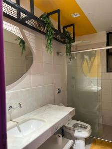 a bathroom with a sink and a toilet at Belô Hostel in Belo Horizonte