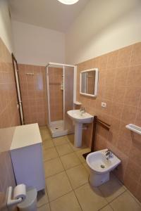a bathroom with a toilet and a sink at Bilocale Lavanda - 100 mt. dal mare con clima in Marina di Campo +17 photos