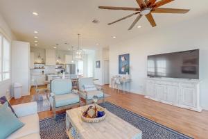 a living room with a couch and a ceiling fan at Sunset Bay in Galveston