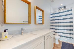 a bathroom with a sink and a toilet at Sunset Bay in Galveston +17 photos