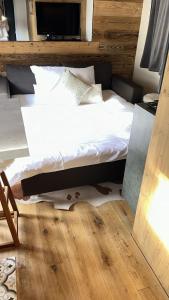 a bed sitting on top of a wooden floor at Chalet at Ski Lift (Gsteig b. Gstaad) in Gsteig