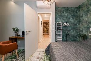 a bedroom with a bed and a desk with a chair at Luxury Tropical Apartment at Budapest in Budapest