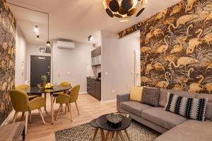 a living room with a couch and a table at Luxury Tropical Apartment at Budapest in Budapest