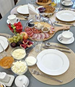 a table with plates of food on a table at Hotel Times in Bukhara +20 photos