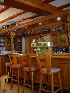 a bar in a restaurant with chairs and a counter at Gasthaus Debelius Beltershausen in Marburg an der Lahn