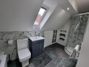 e bagno con servizi igienici, lavandino e doccia. di Sutton Apartment, Greater London a Sutton