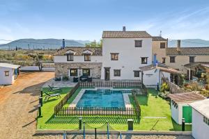 a villa with a swimming pool in front of a house at Luxe Mediterranean Masia BBQ Pool Chillout 