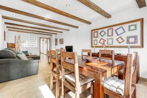a living room with a wooden table and chairs at Luxe Mediterranean Masia BBQ Pool Chillout in Mas de Catalá