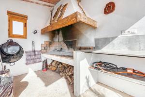 a kitchen with a stove with a fireplace at Luxe Mediterranean Masia BBQ Pool Chillout in Mas de Catalá