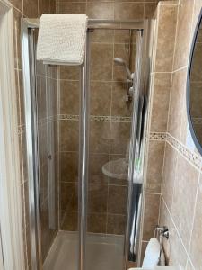 a shower with a glass door in a bathroom at Most Easterly in Pakefield