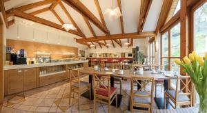 a kitchen with wooden ceilings and a table with chairs at Das Palatinum in Sankt Martin