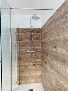 a bathroom with a shower with a glass door at SeaView Ericeira in Ericeira