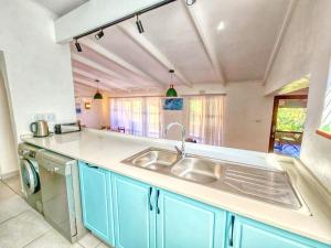 a kitchen with a sink and a dishwasher at San Lameer 2401 by Top Destinations Rentals in Southbroom