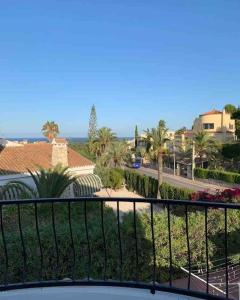a balcony with a view of a street and palm trees at Casa Beavan in Alicante