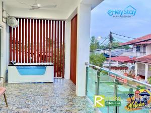 a balcony with a view of a pool at Klebang 4B3B-21Pax Pooltable KaraoK Jaccuzi TownArea in Kelebang Besar