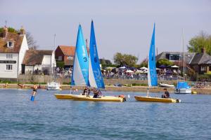 a group of boats with sails in the water at 4BR Beach House sleeps 10 - 5 mins walk to the Sea in West Wittering