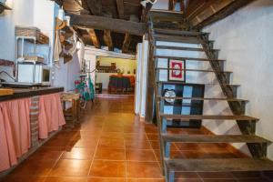 a hallway with a spiral staircase in a house at LA CASITA DE LA CORREDERA in Candeleda