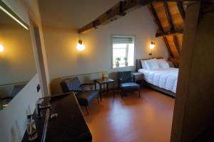 1 dormitorio con 1 cama, mesa y sillas en Den Eijngel bed and breakfast, en Boxtel