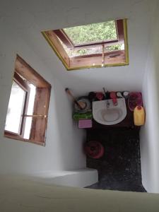 a small bathroom with a toilet and a window at Wakanda cottage kibale in Fort Portal