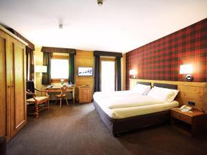 Posteľ alebo postele v izbe v ubytovaní Hotel Orso Grigio