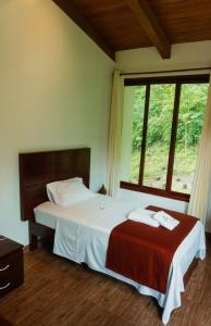 a bedroom with a large bed and a window at Donce Extremo in San Carlos