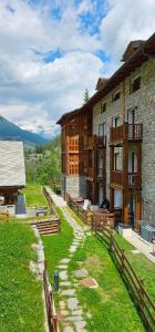 a stone building with a path leading up to it at Luxury apartment with pool, sauna, SPA in Champoluc