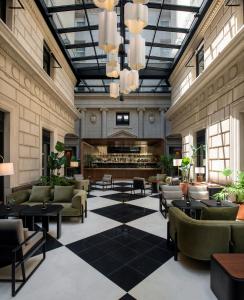 a lobby with couches and tables and a fireplace at Hotel Casa Lucia in Buenos Aires
