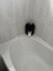 a white toilet in a bathroom with a white tile wall at Bonningtons - Charming 2 Bed Property In Brentwood in Shenfield