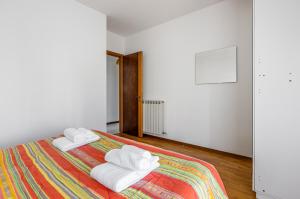 a bedroom with a bed with two towels on it at Comfortable Apartment with Parking & Terrace in Perugia