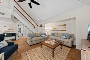 a living room with two couches and a coffee table at 770 Spinnaker Beach House in Seabrook Island